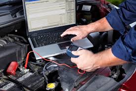 Technicial using computer to diagnose engine problem
