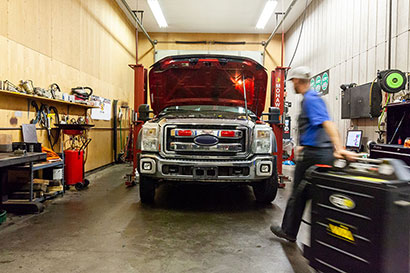 Technician working on a vehicle - Integrity Auto Services